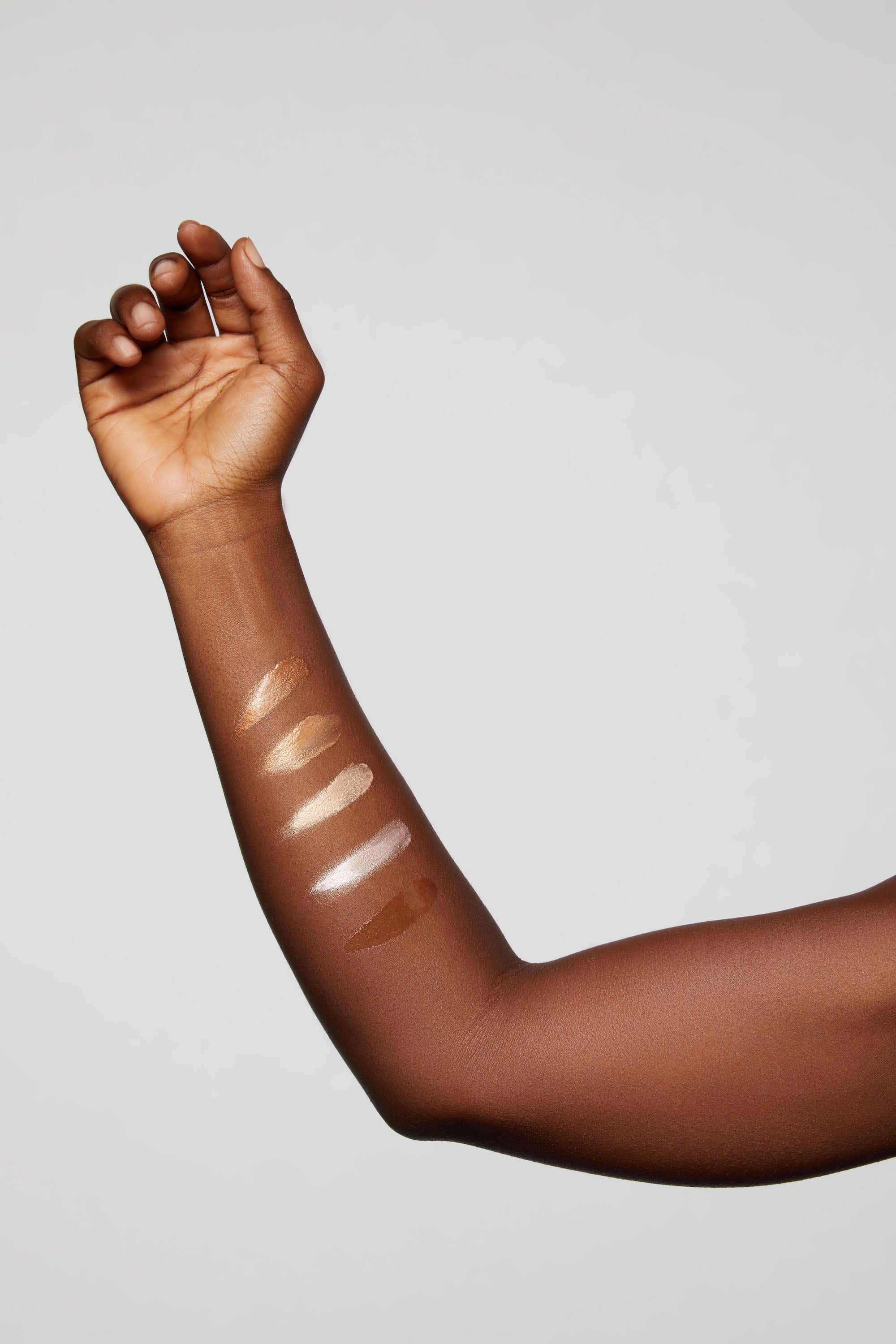 Swatches of Hyper Shine High Lite Kit on dark skin - Lite Bronze